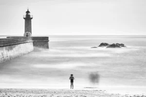 Girl at beach in Foz, Portugal, with blurry people next to her.