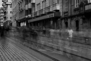 Man standing out in sea of blurry people in Porto.