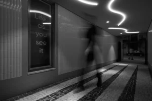 Blurry man walking in atmospheric corridor in Porto.